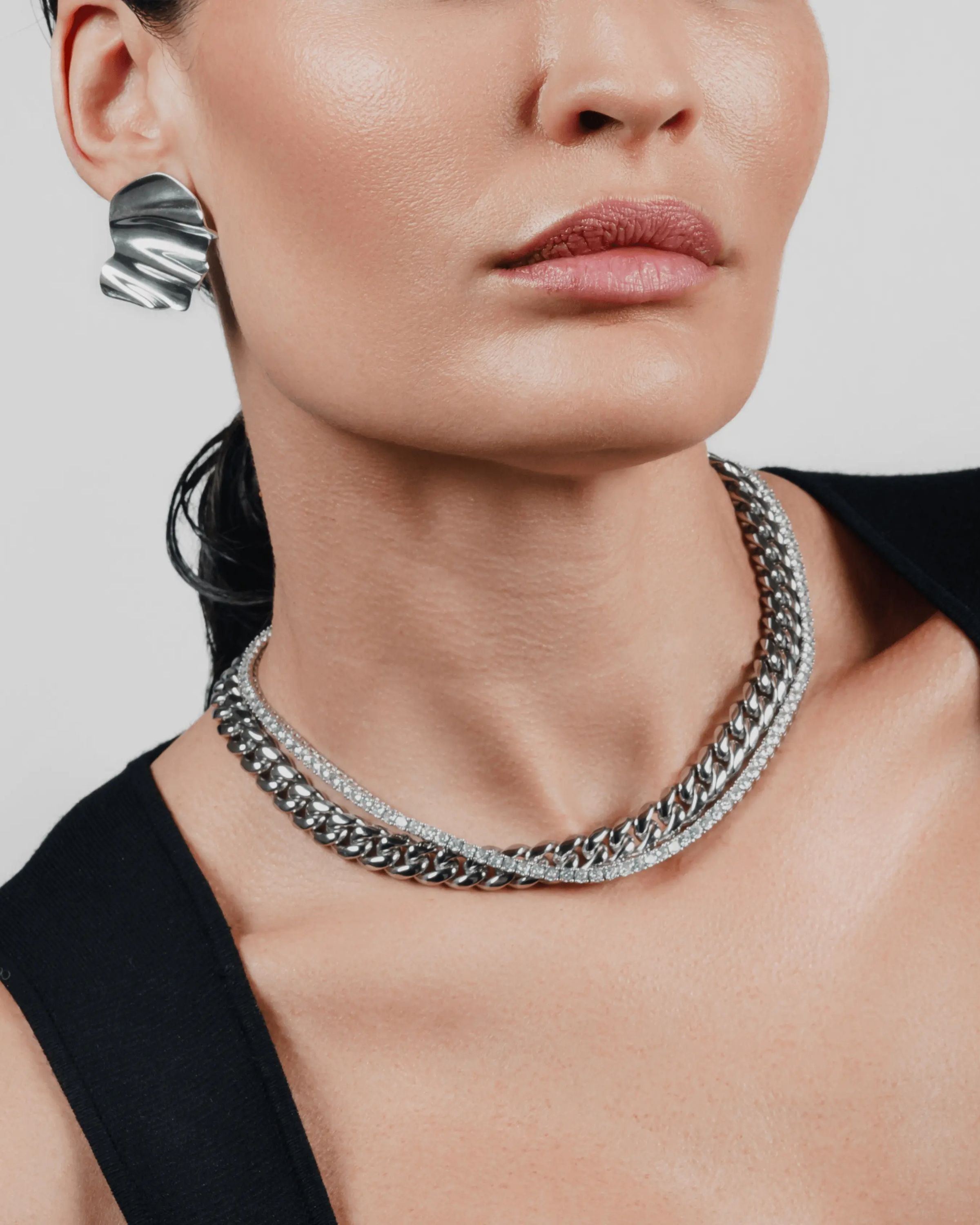 Two-piece layered necklace stack in silver, featuring a curb chain and a tennis chain. ||| SILVER