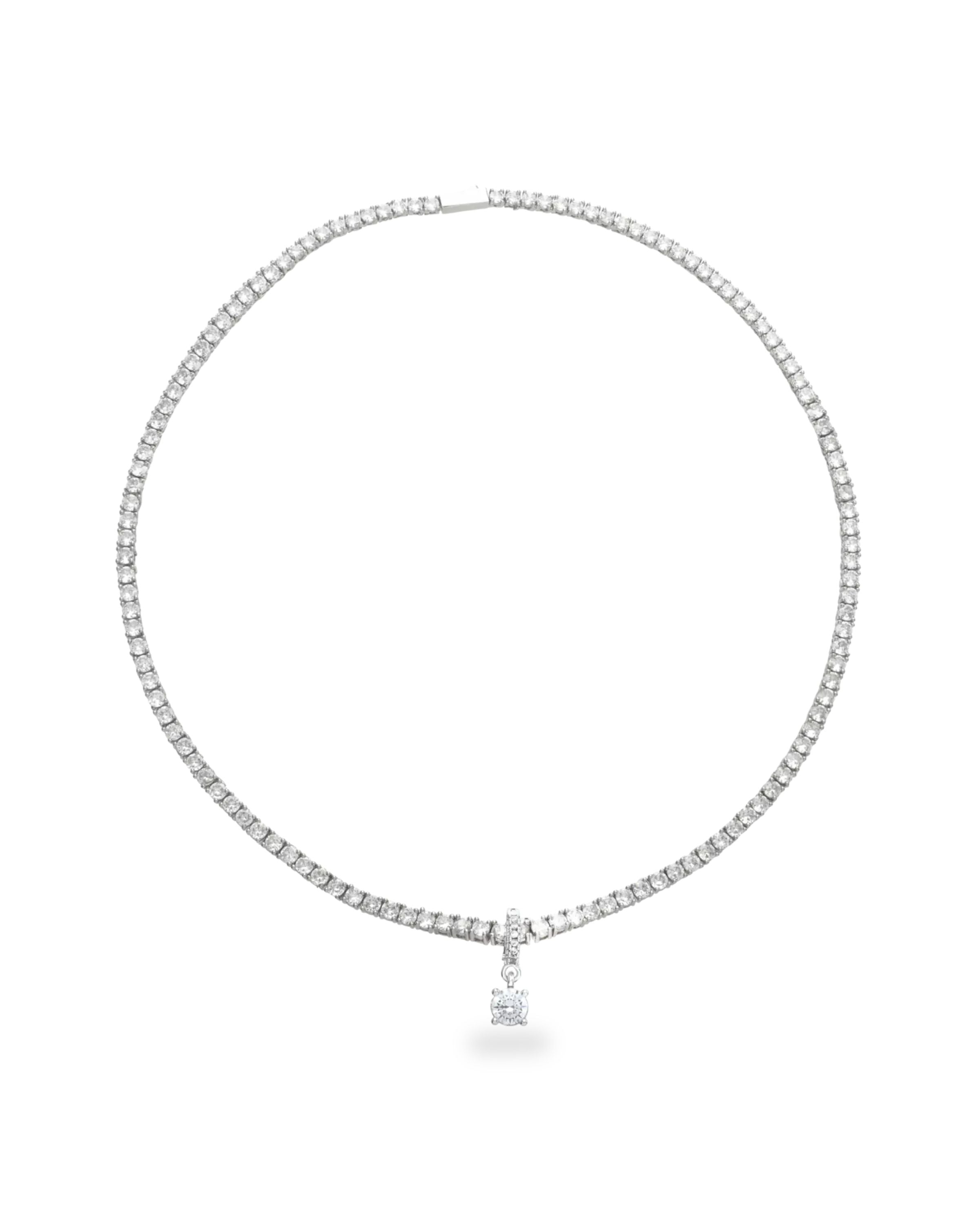 The Solitaire Tennis Necklace, which is a single silver tennis necklace featuring a round-cut solitaire pendant at the center.