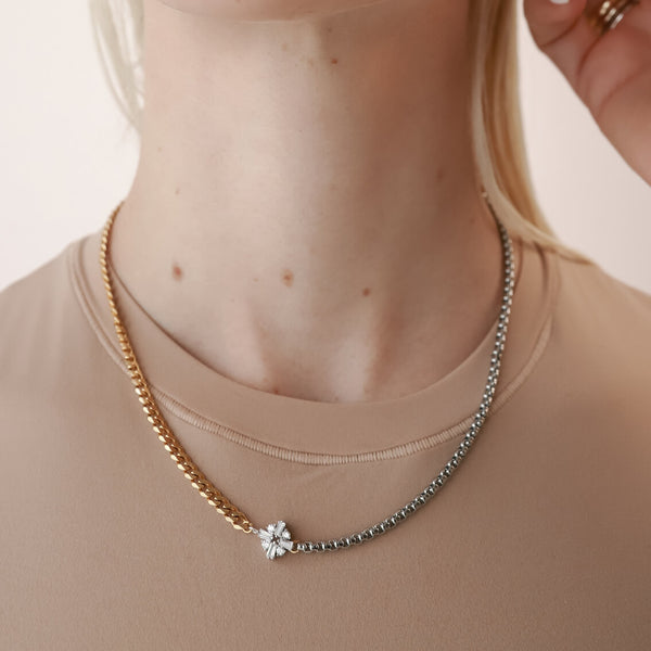 Model wearing the FUSION NECKLACE is made of mixed Stainless steel chain and18k gold plated cuban chain connected with a Sterling Silver rhombus shaped zirconia charm.