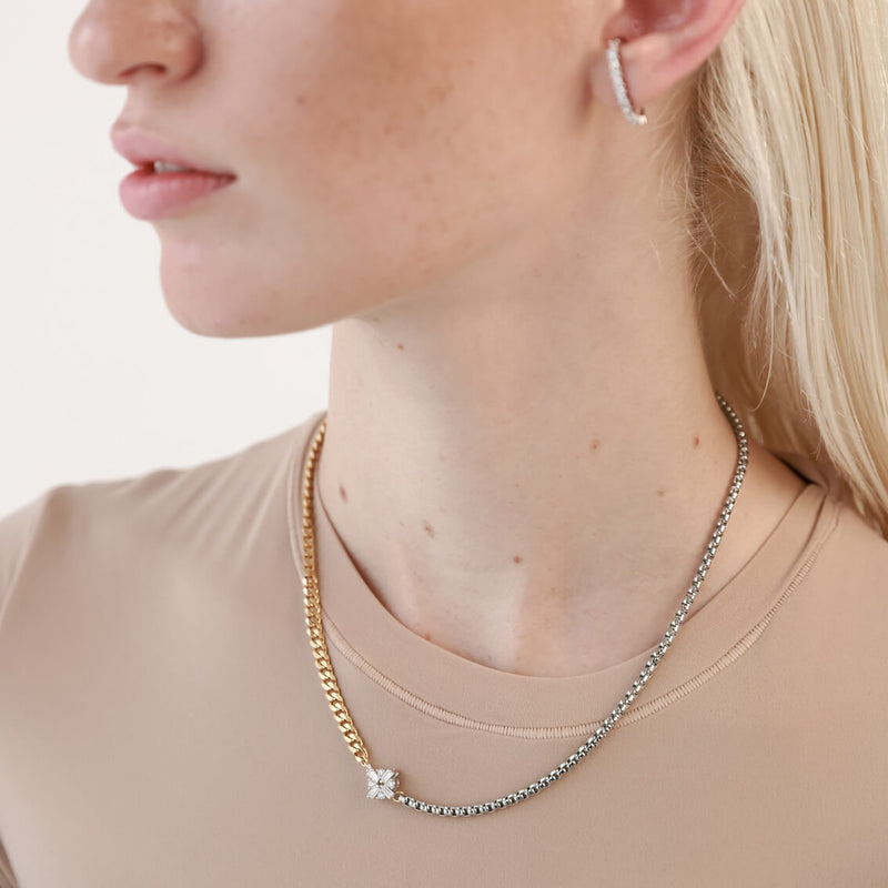 Model wearing the FUSION NECKLACE is made of mixed Stainless steel chain and18k gold plated cuban chain connected with a Sterling Silver rhombus zirconia charm.
