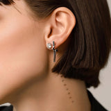 The Flying Solo Stars Earrings, a two-piece silver earring set featuring a long, textured bar earring and a stud earring with a large round cubic zirconia.



