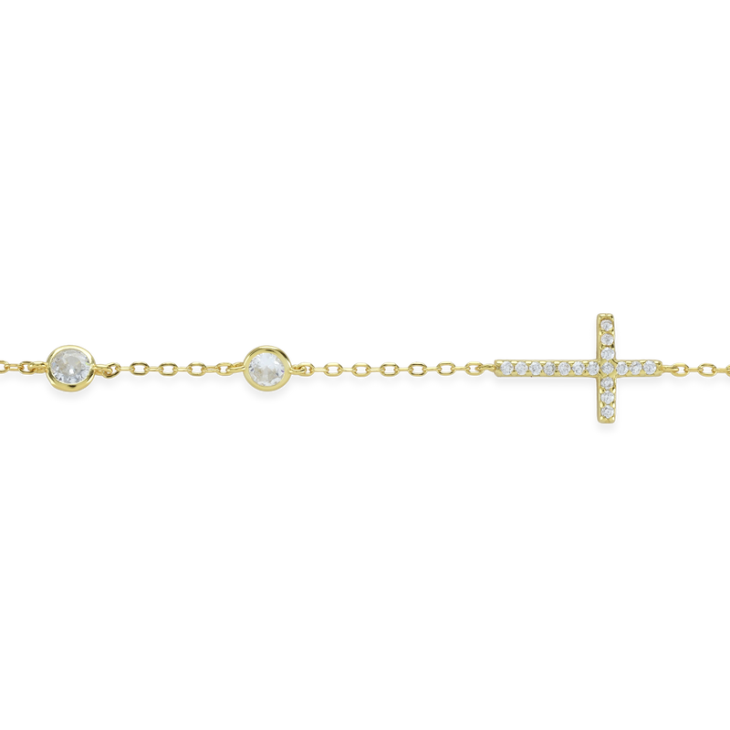 The Fine Cross Bracelet which is a gold bracelet featuring a dainty chain adorned with three shimmering diamonds and a cross charm set with sparkling diamonds.