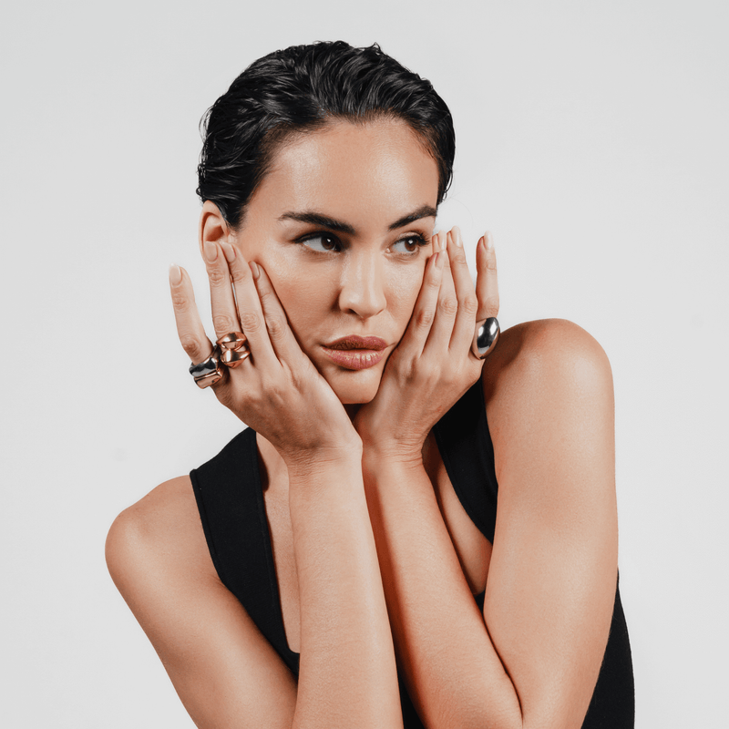 Model wearing HIGH PEAK RING SET in gold and silver paired with the CHUNKY DOME RING SET and Fierce Ring in silver. 