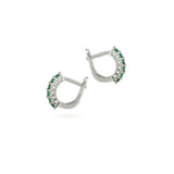 The Prong Emerald Hoops, a pair of silver hoop earrings featuring prong-set emerald accents.