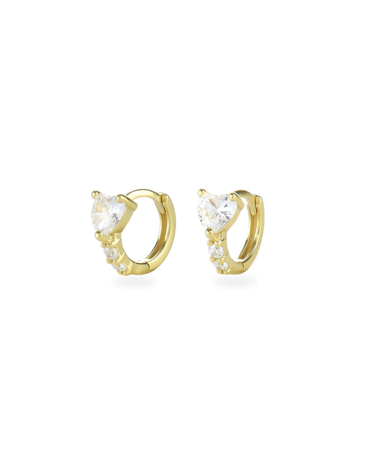 The One Stone Gold Piercing Hoops, which are a pair of gold hoop earrings, feature a central heart-shaped stone with additional sparkling accents along the band.