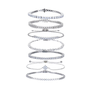 The Supernova Tennis Stack, a set of 7 silver bracelets featuring various styles of tennis bracelets with sparkling cubic zirconia stones.