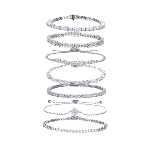 The Supernova Tennis Stack, a set of 7 silver bracelets featuring various styles of tennis bracelets with sparkling cubic zirconia stones.