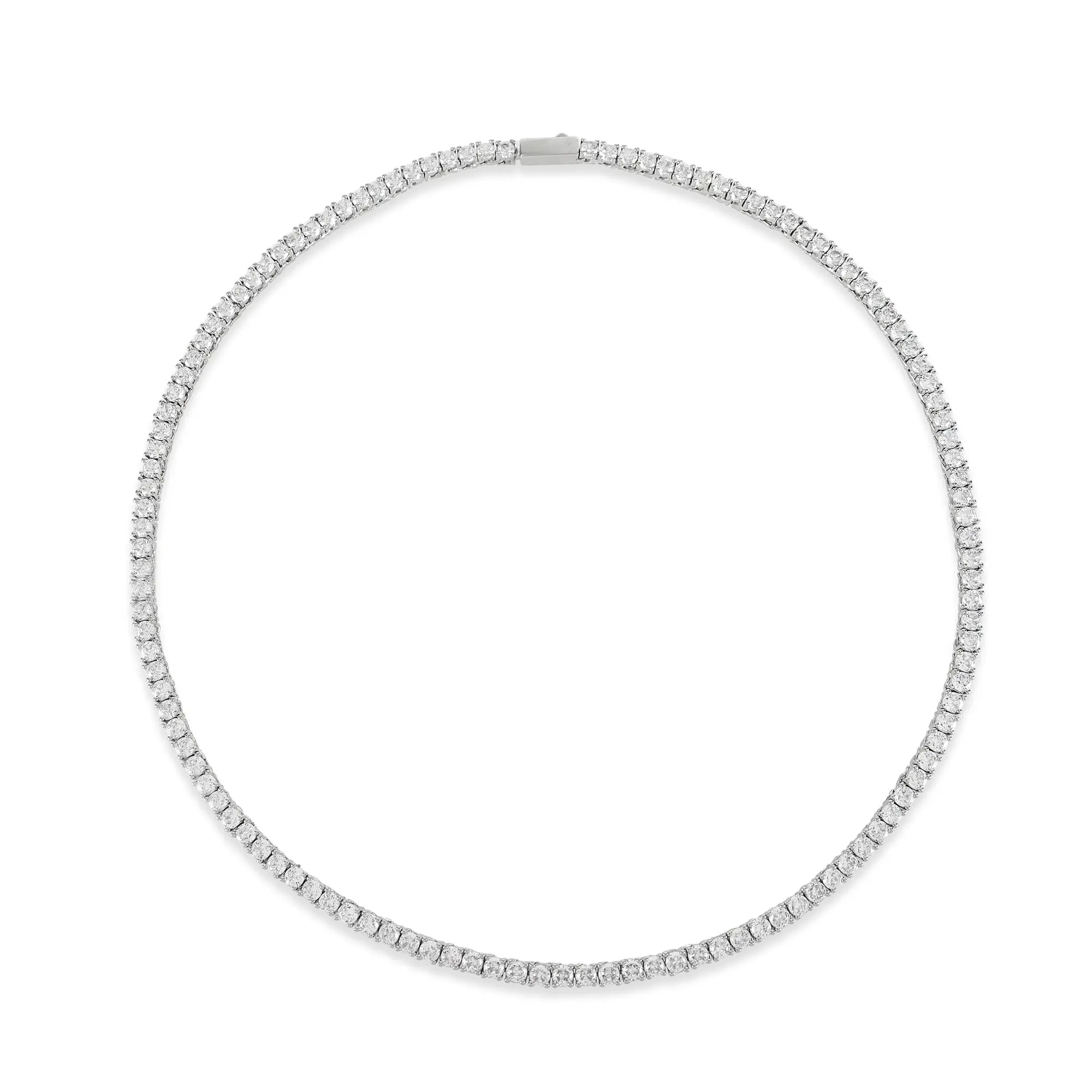 The Tennis Necklace, a silver necklace featuring a continuous line of sparkling diamond-like stones.