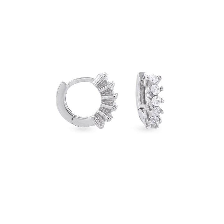The Tiny Huggies Hoop, a pair of small silver hoop earrings that feature a row of sparkling cubic zirconia stones set in a  pointed, triangular pattern.||| SILVER