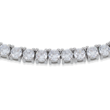 The Tennis Necklace, a silver necklace featuring a continuous line of sparkling diamond-like stones.