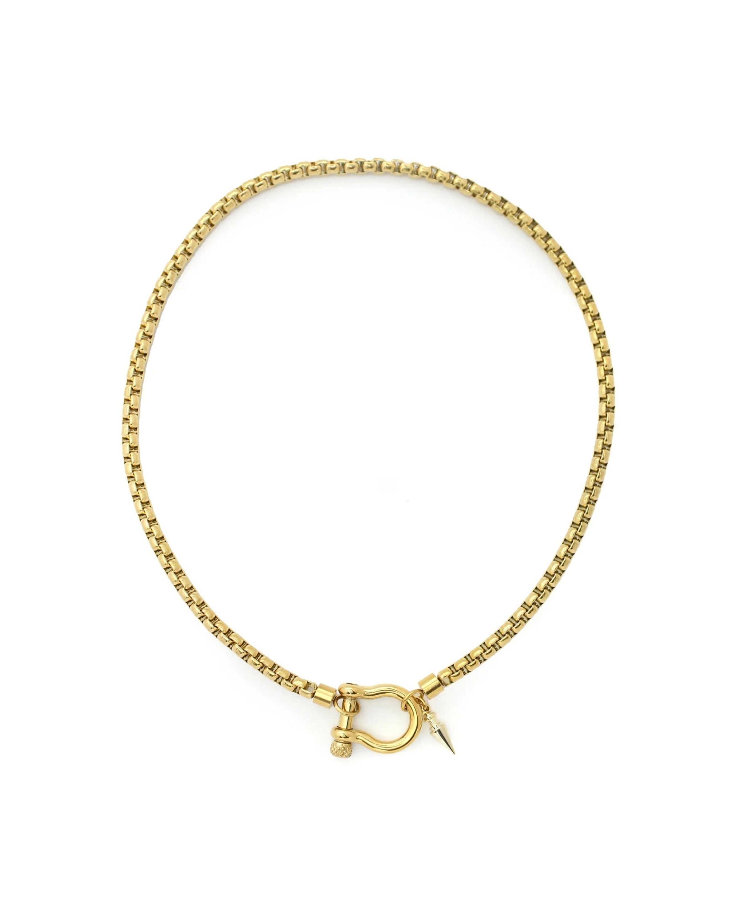 The Herradura Spike Necklace, a gold necklace with a spike charm and a unique horseshoe clasp.
