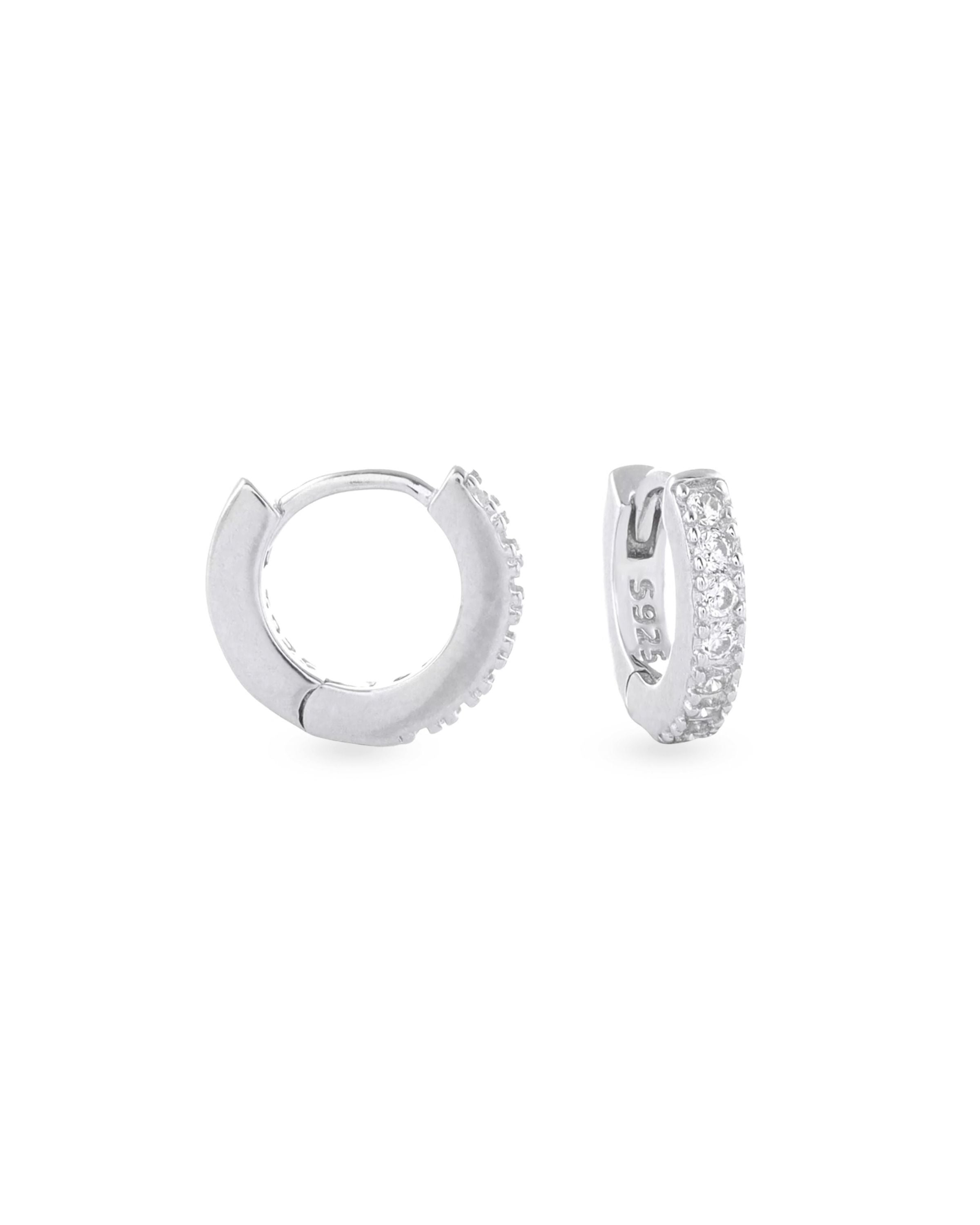 The Mini Clear Huggies, a pair of small silver hoop earrings with sparkling clear cubic zirconia stones.||| SILVER