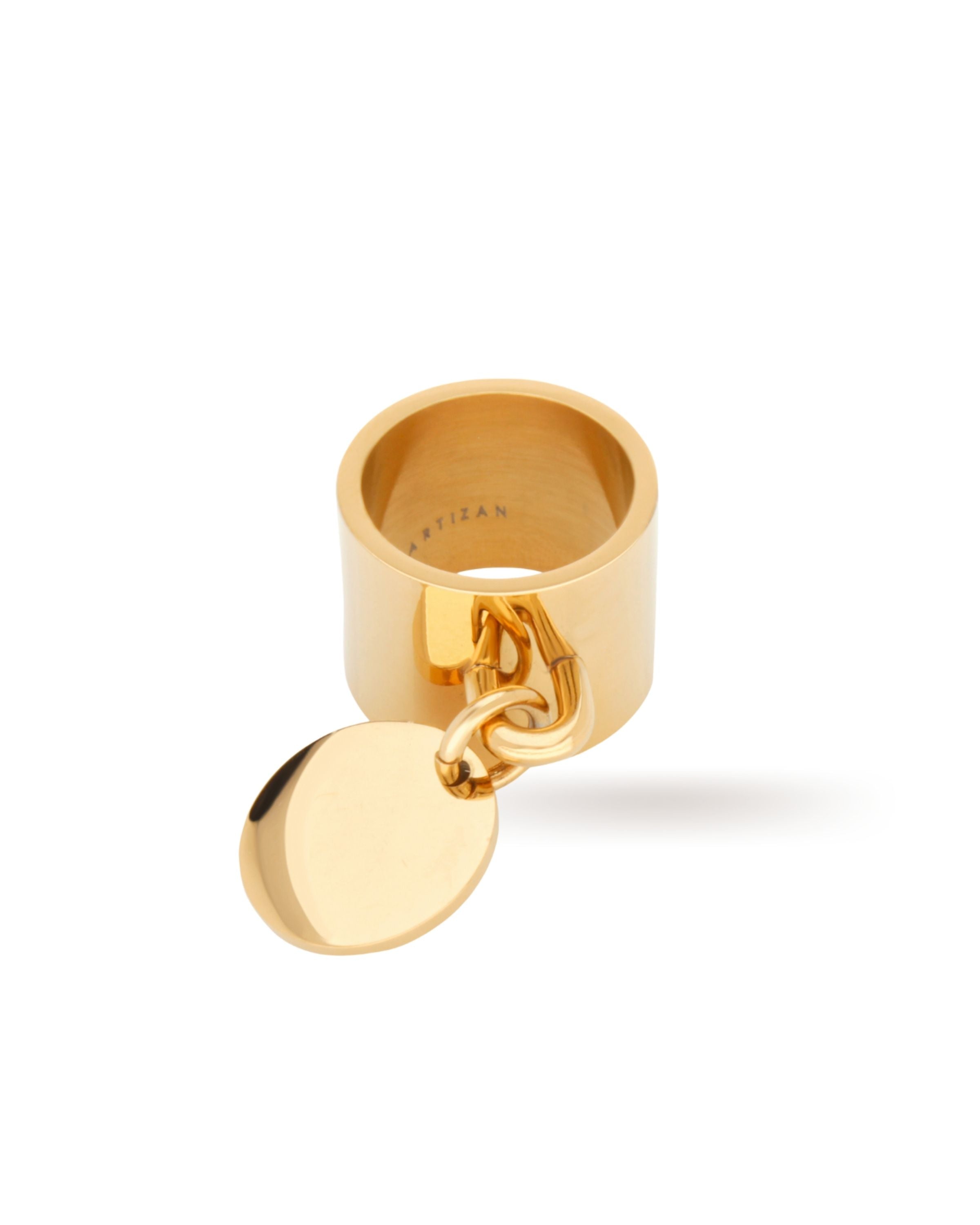 The Coin Ring, which is a bold gold statement ring featuring a thick band with a dangling chain and a circular pendant. ||| GOLD