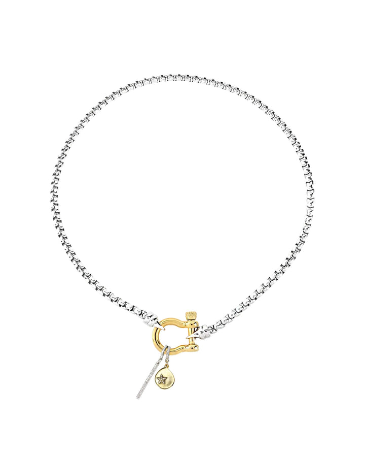 The HERRADURA SIGNATURE DOUBLE TAKE featuring a silver chain with a gold horseshoe clasp and dangling charms, including a pavé bar and a gold star pendant. ||| GOLD