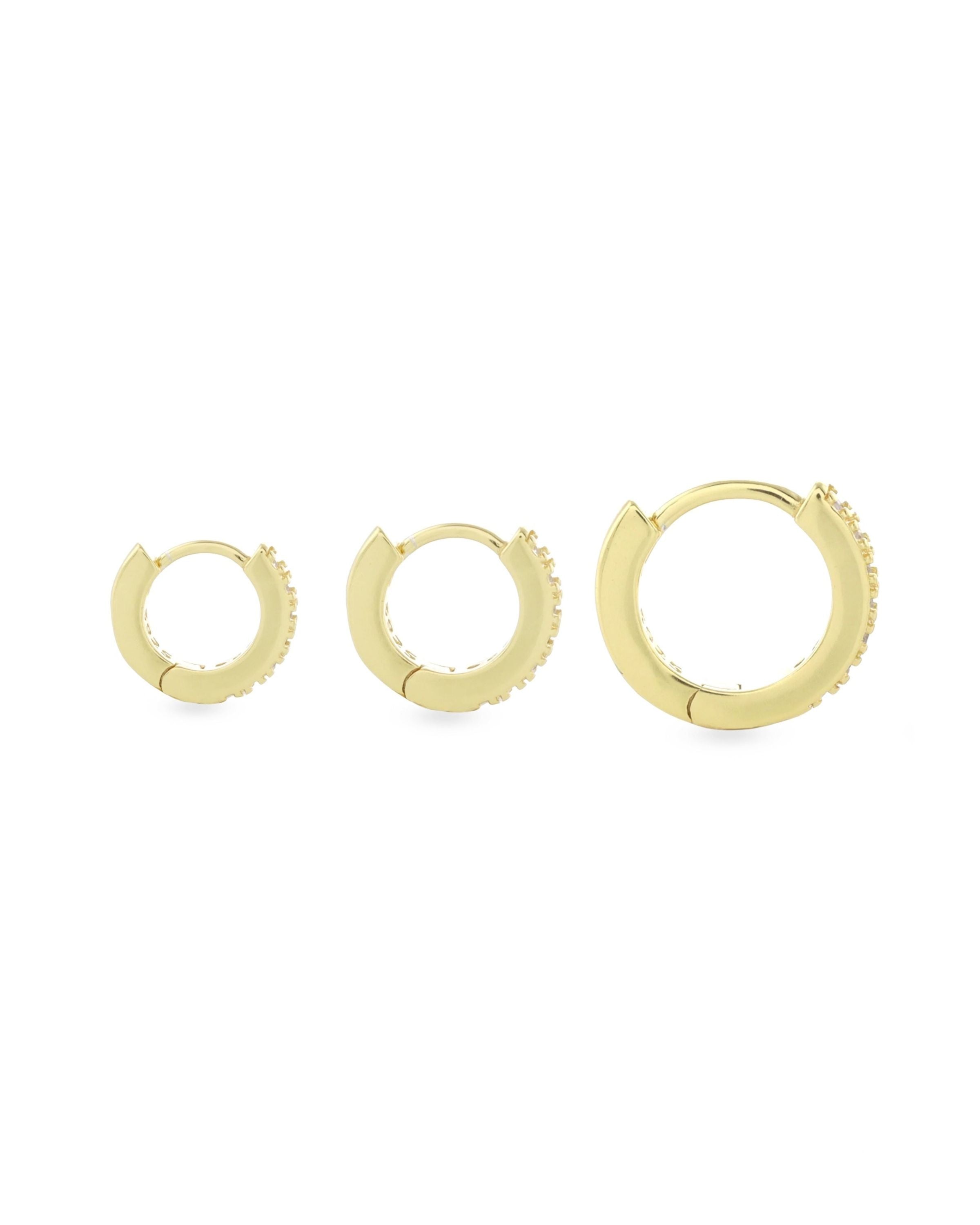 The Mini Clear Huggies, a pair of small gold hoop earrings with sparkling clear cubic zirconia stones.||| GOLD