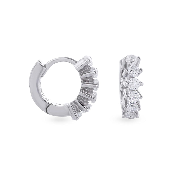 The Tiny Huggies Hoop, a pair of small silver hoop earrings that feature a row of sparkling cubic zirconia stones set in a  pointed, triangular pattern.||| SILVER