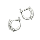 "The Prong Hoops, which are a pair of silver hoop earrings, showcase a unique design with bold prong details that create a modern, architectural aesthetic. These statement earrings are lightweight and versatile, perfect for enhancing both casual and formal outfits with a sleek, contemporary touch." ||| SILVER