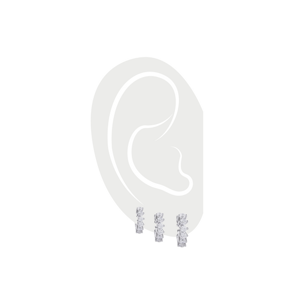 The Tiny Huggies Hoop Set, a trio of silver-tone hoops with intricate details, perfect for stacking or wearing individually. ||| SILVER