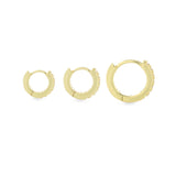 The Mini Clear Huggies, a pair of small gold hoop earrings with sparkling clear cubic zirconia stones.||| GOLD