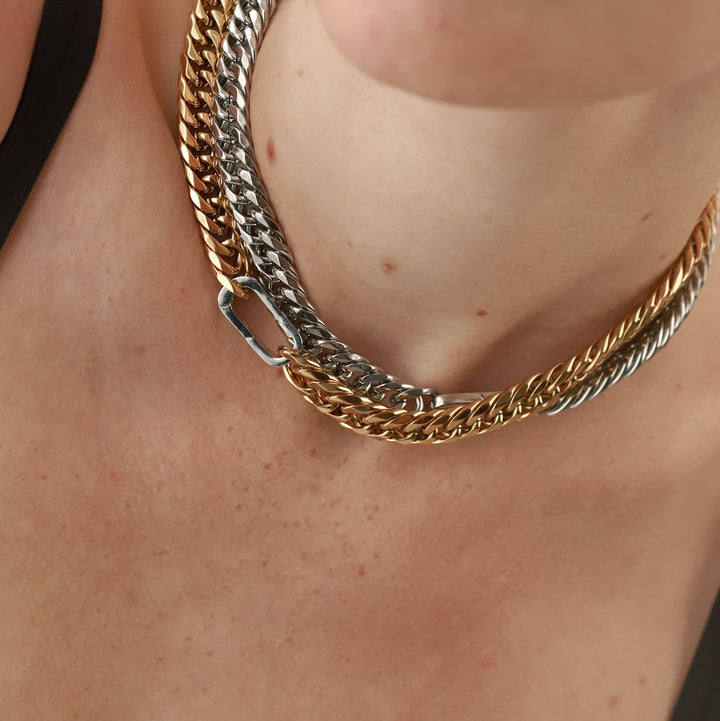 Model wearing the Just Click Gold Chain, a single gold chain with a silver lobster clasp closure and another just click chain in silver. ||| SILVER