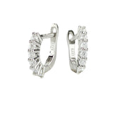 The Prong Hoops, which are a pair of silver hoop earrings, feature a stunning row of sparkling prong-set cubic zirconia stones along the front for a dazzling effect. These elegant hoops are perfect for adding a touch of glamour to any outfit, making them versatile for both everyday wear and special occasions ||| SILVER