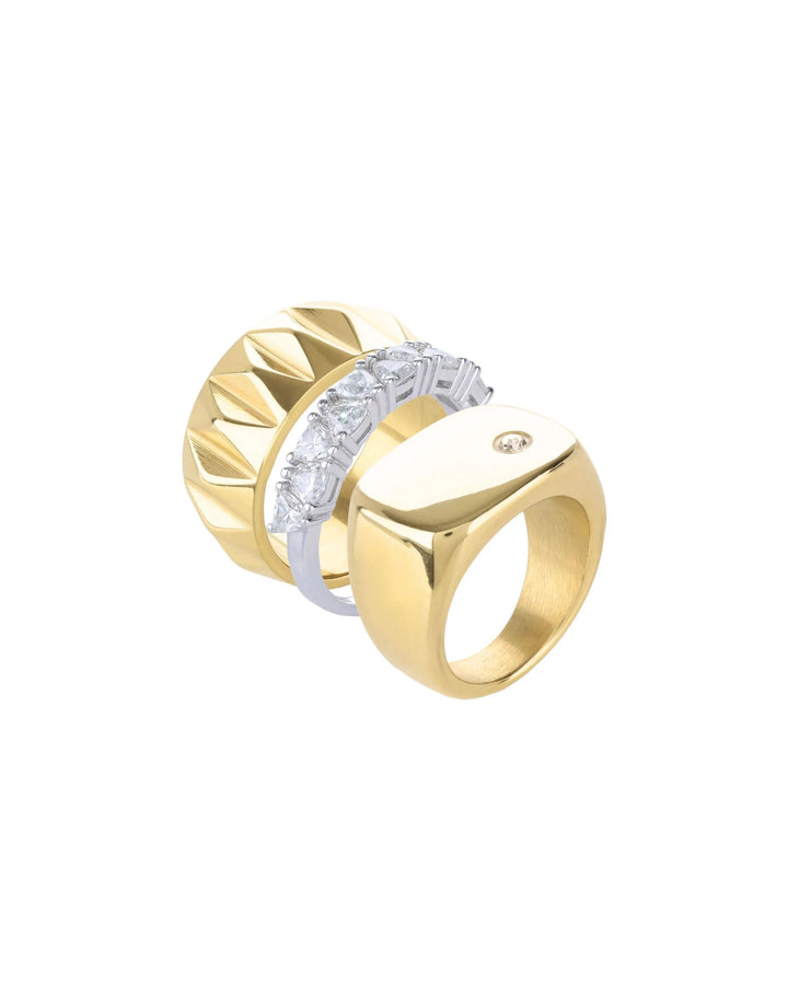 The Madness Ring Stack, a three-piece gold and silver ring stack featuring a gold pinky ring with a single diamond-like stone, a silver ring with diamond-like accents, and a gold ring with a textured geometric design.