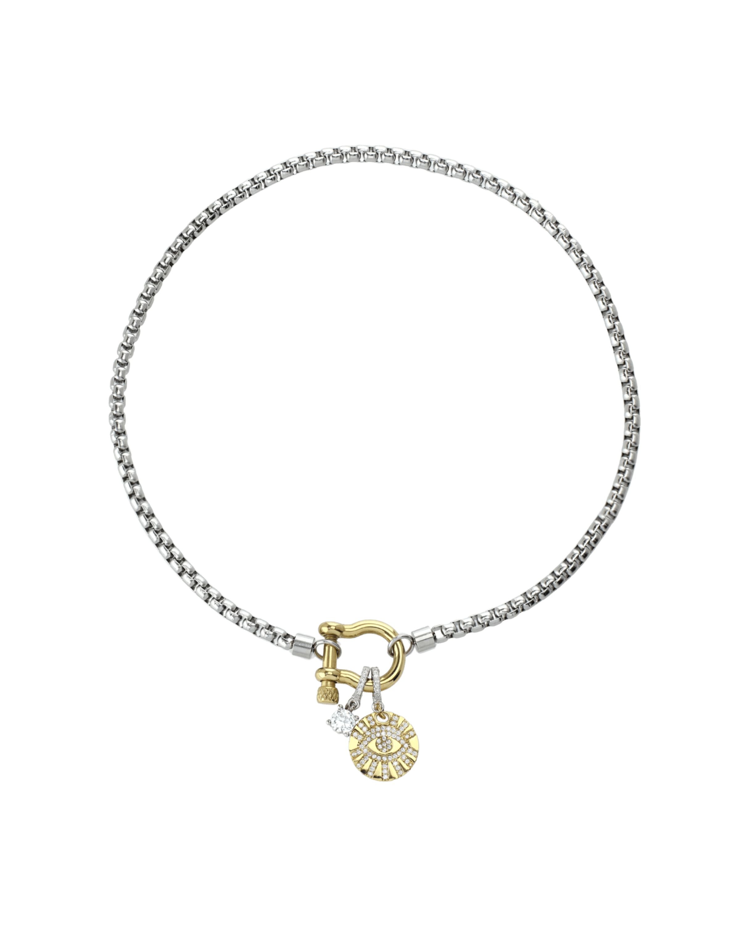 The Herradura Clip On Evil Eye Necklace, a silver and gold necklace featuring a box chain with a gold horseshoe clasp and an evil eye charm accented with diamond-like stones.