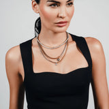 Gold and silver MIX TENNIS COMPASS NECKLACE SET layered on model, featuring a compass pendant, cubic zirconia, and mixed metal chains.