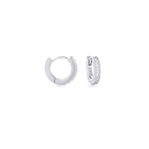 The Mini Clear Huggies, a pair of small silver hoop earrings with sparkling clear cubic zirconia stones. ||| SILVER