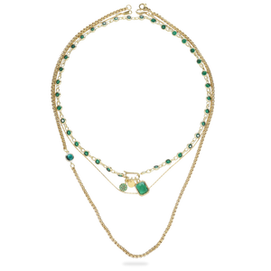 The CAN OPENER GOLD EMERALD NECKLACE SET which is a three-piece Layered Gold Necklace Set featuring a Can Opener chain with emerald-cut gemstones and a delicate pendant necklace with a green gemstone.