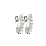 The Prong Hoops, which are a pair of silver hoop earrings, feature a stunning row of sparkling prong-set cubic zirconia stones along the front for a dazzling effect. These elegant hoops are perfect for adding a touch of glamour to any outfit, making them versatile for both everyday wear and special occasions ||| SILVER