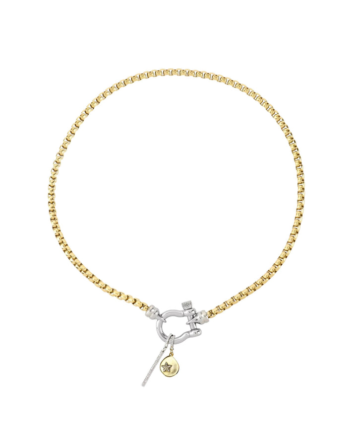 The HERRADURA SIGNATURE DOUBLE TAKE featuring a gold chain with a silver horseshoe clasp and dangling charms, including a pavé bar and a gold star pendant. ||| SILVER