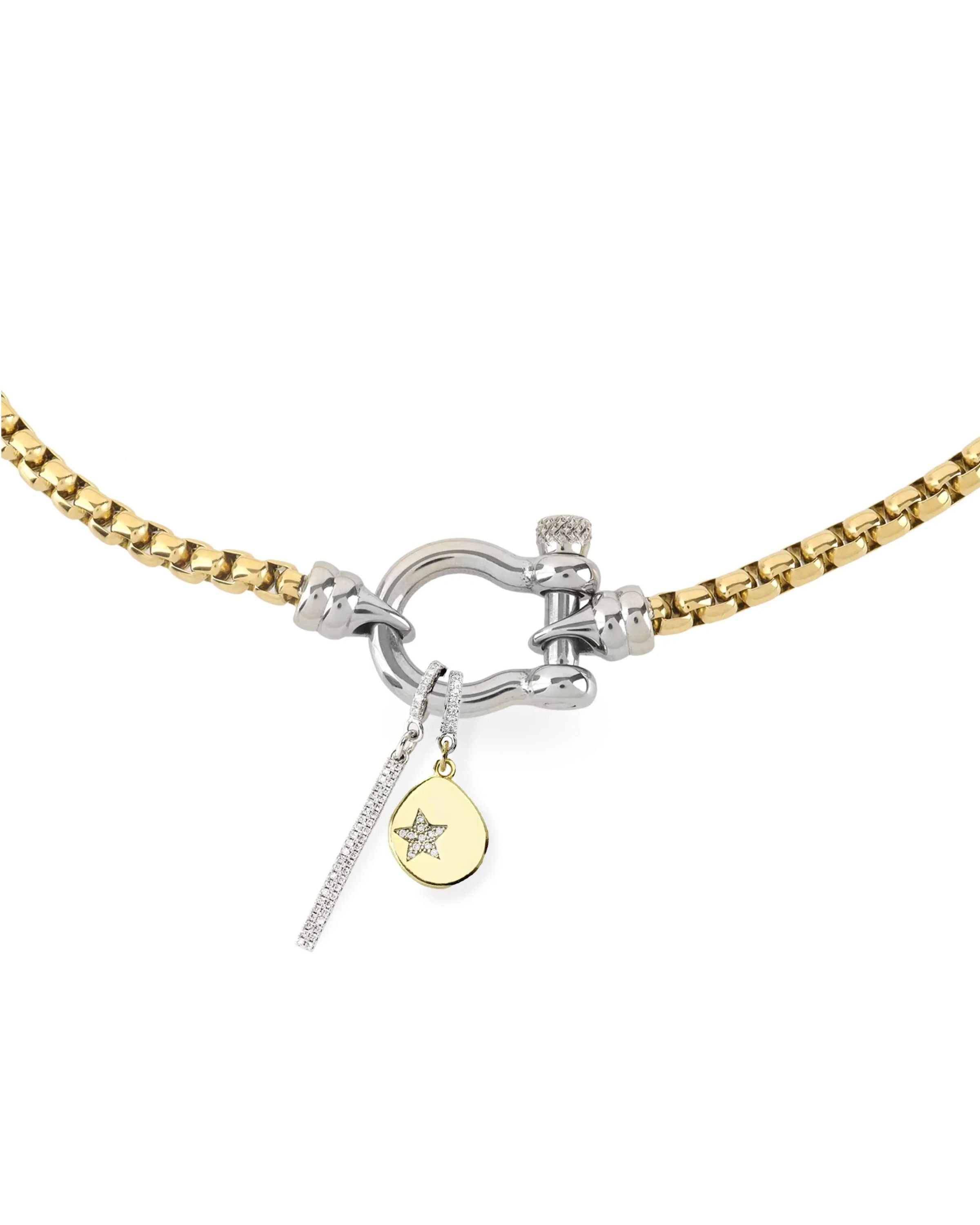 The HERRADURA SIGNATURE DOUBLE TAKE featuring a gold chain with a silver horseshoe clasp and dangling charms, including a pavé bar and a gold star pendant. ||| SILVER