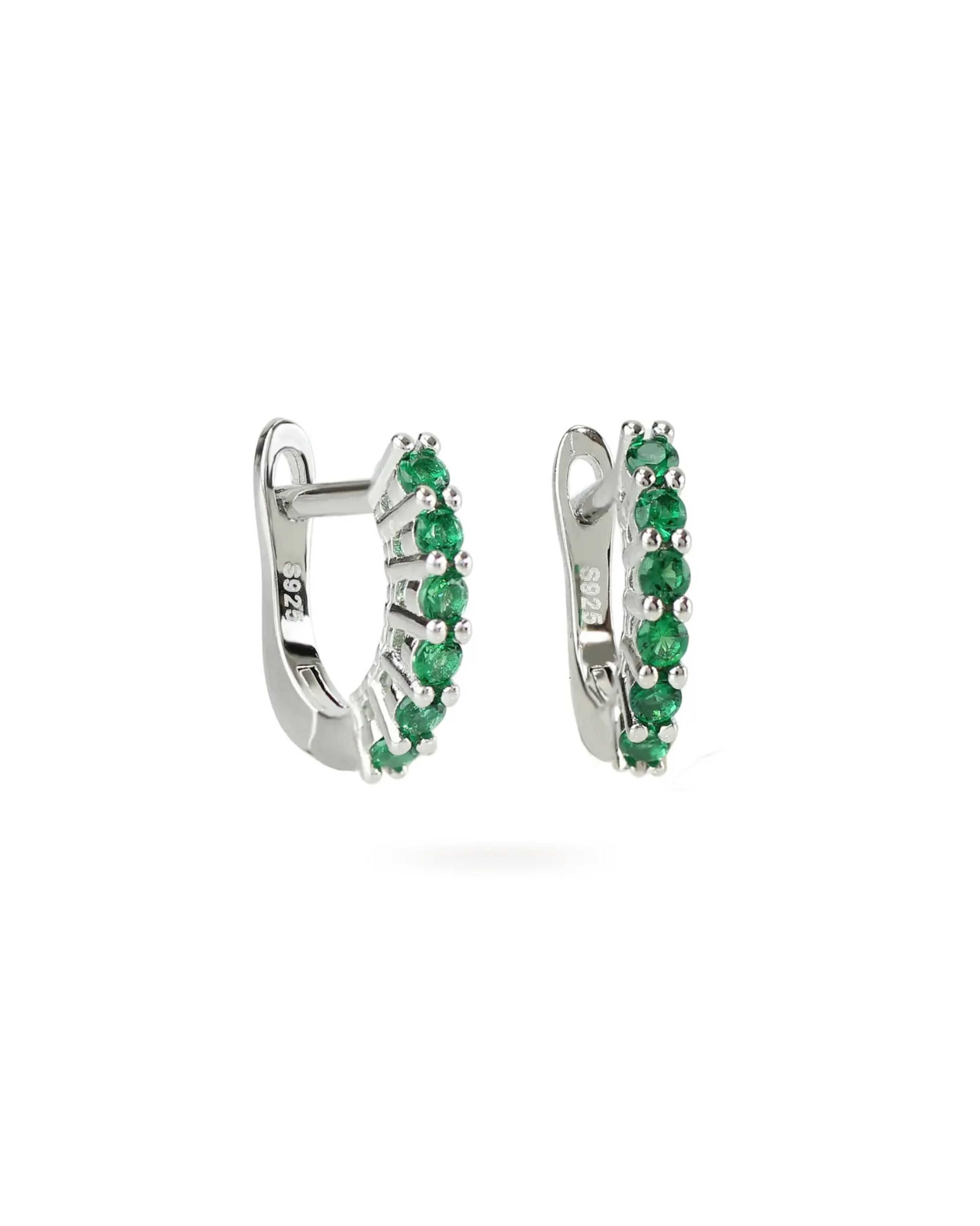 The Prong Emerald Hoops, a pair of silver hoop earrings featuring prong-set emerald accents.
