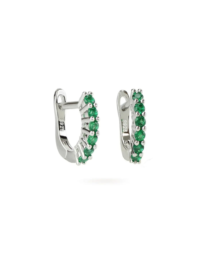 The Prong Emerald Hoops, a pair of silver hoop earrings featuring prong-set emerald accents.