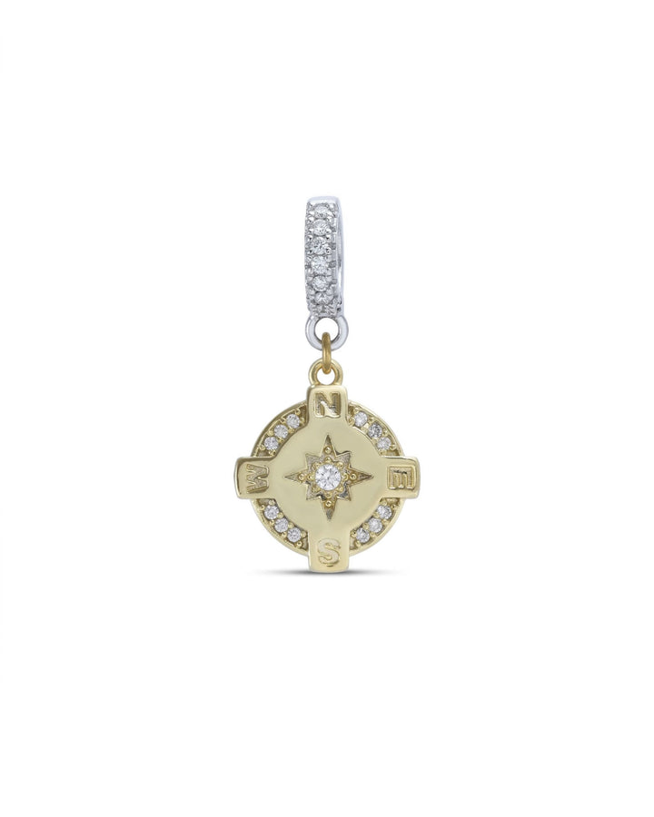 The Go North Clip On Charm, a gold compass charm accented with diamond-like stones.