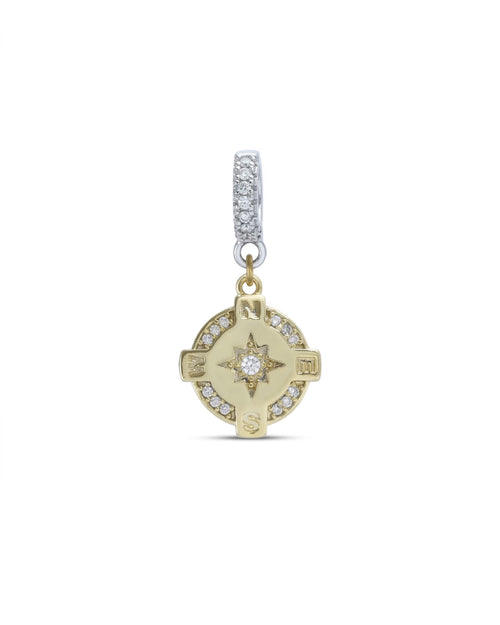 The Go North Clip On Charm, a gold compass charm accented with diamond-like stones.