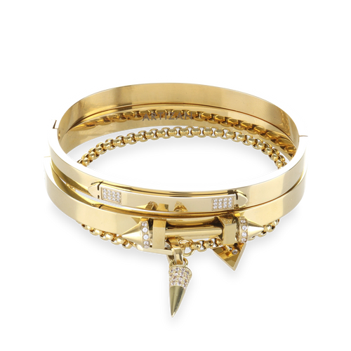 The ARROWHEAD BRACELET STACK, a stylish gold bangle set featuring 3 bracelets with intricate arrowhead details and sparkling diamonds. Includes a chain bracelet with arrowhead and triangle charms. 