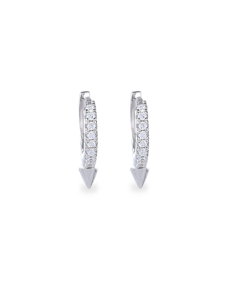 The MINI SHOT HOOP, which is a pair of sleek silver earrings, features a delicate hoop design adorned with sparkling cubic zirconia stones and finished with a pointed charm at the base for a modern edge. Perfect for adding a subtle yet bold statement to any outfit.