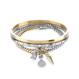 The Mix Gear Bracelet Stack, a four-piece gold and silver bracelet stack featuring two bangles and two chains with a variety of charms, including a teardrop charm, a spike charm, and a disc charm accented with diamond-like stones.
