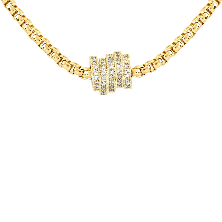 The Nut Necklace, a gold box chain with a gold nut-shaped pendant encrusted with stones. ||| GOLD