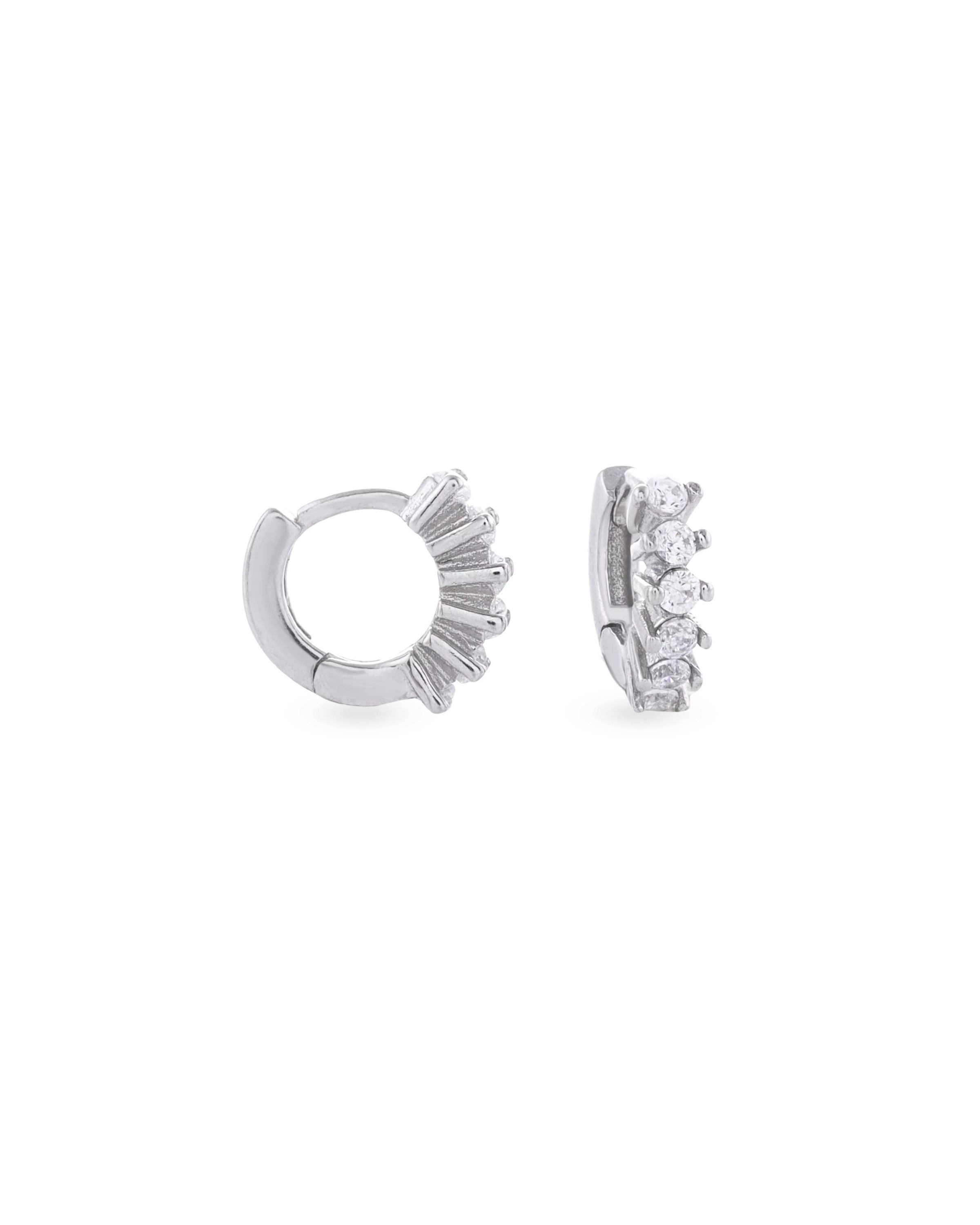 The Tiny Huggies Hoop, a pair of small silver hoop earrings that feature a row of sparkling cubic zirconia stones set in a  pointed, triangular pattern. ||| SILVER/6mm