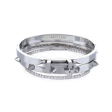 The Silver Arrow Bracelet Stack, a three-piece silver bracelet stack featuring two bangles with spike accents and and a diamond-like tennis bracelet.