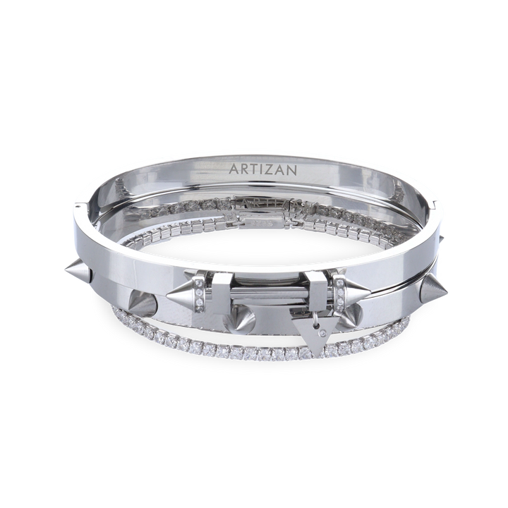 The Silver Arrow Bracelet Stack, a three-piece silver bracelet stack featuring two bangles with spike accents and and a diamond-like tennis bracelet.