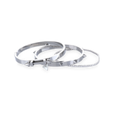 The Silver Arrow Bracelet Stack, a three-piece silver bracelet stack featuring two bangles with spike accents and and a diamond-like tennis bracelet.