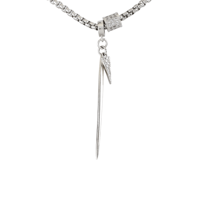 The Needle Necklace, which is a single-piece silver necklace, features a sleek needle-shaped pendant accented with a small sparkling charm, creating a unique and edgy look ideal for statement-making or layering styles.