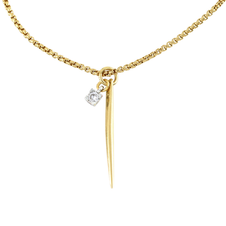 The Needle Solitaire Necklace, which is a single-layer gold necklace, features a sleek needle-shaped pendant accented with a tiny sparkling solitaire crystal. This minimalist yet elegant piece is perfect for everyday wear or layering with other gold necklaces for a chic, modern look.