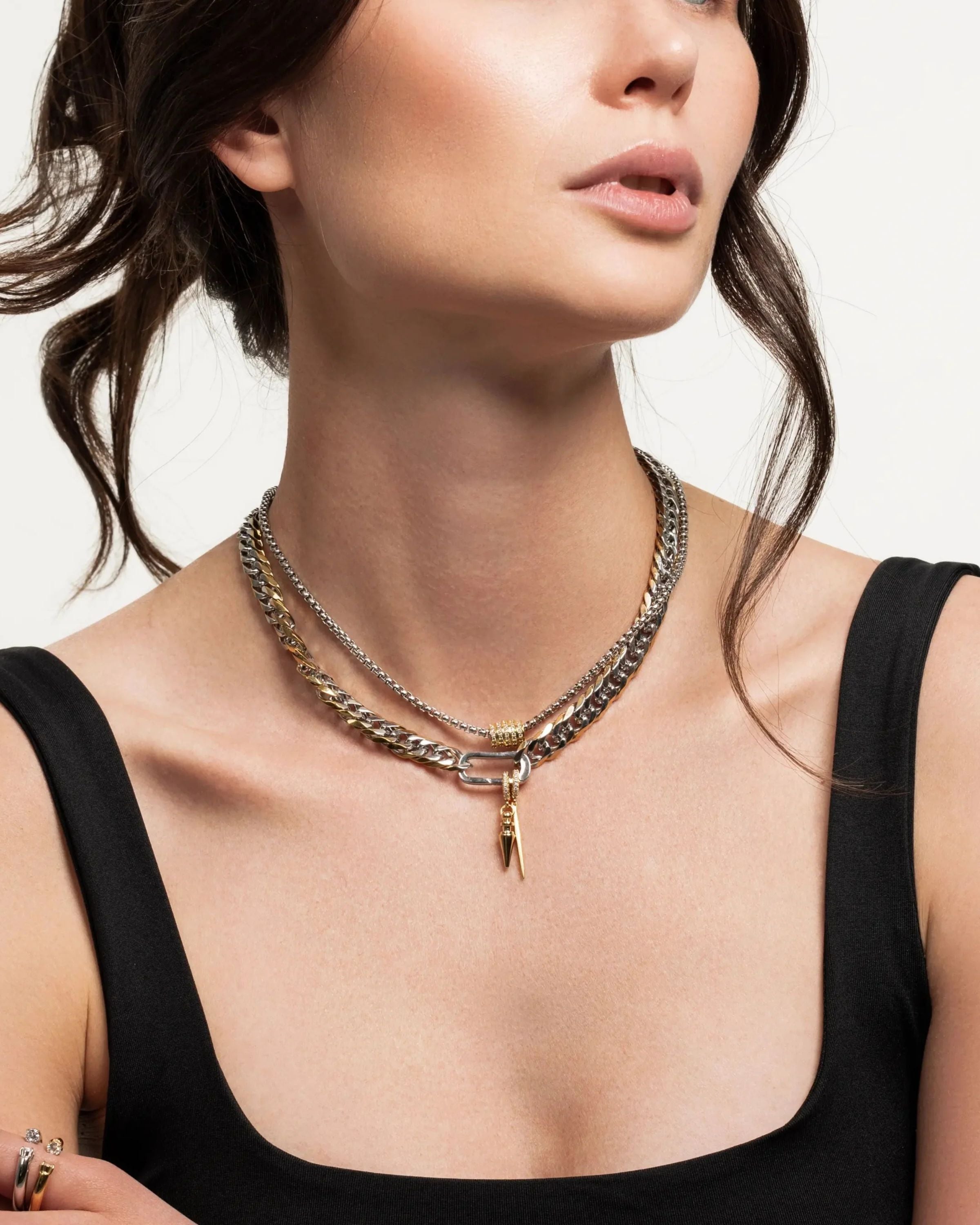 Model wearing the Just Click Nut Layered Necklace Set featuring four gold and silver chains with a mixed metal clasp and nut-inspired charm.