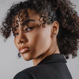 Model wearing the Trio Diamond Earring Chain, a silver earring chain featuring three sparkling cubic zirconia stones.