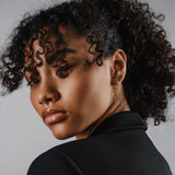 Model wearing the Trio Diamond Earring Chain, a silver earring chain featuring three sparkling cubic zirconia stones.